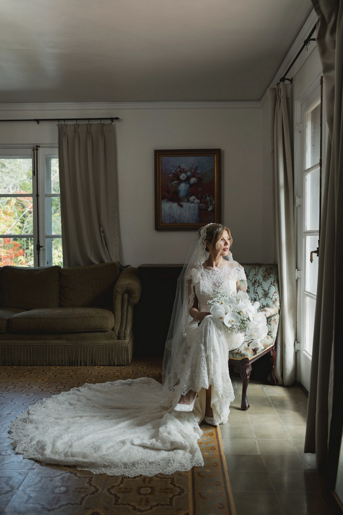 Bride posing for a photographer at Villa Woodbine in Miami, Florida 